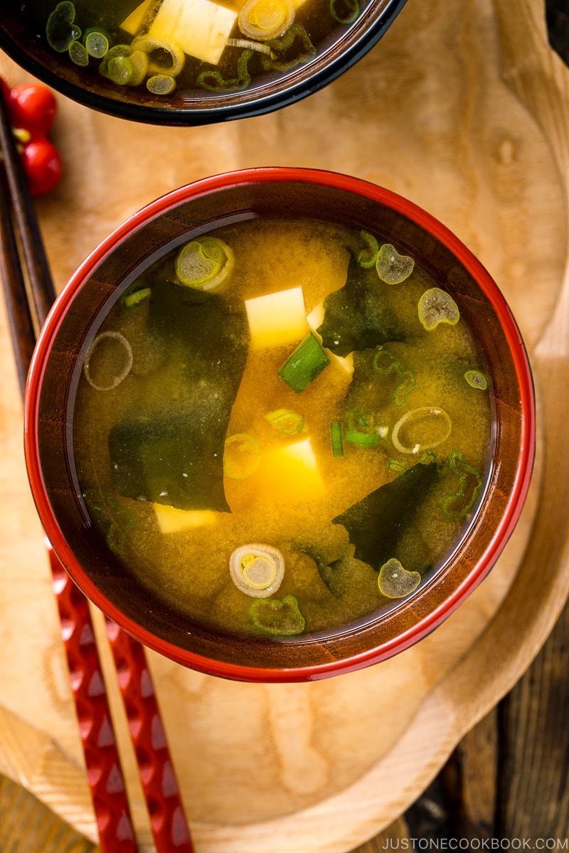 Japanese miso soup bowls containing tofu and wakame miso soup.