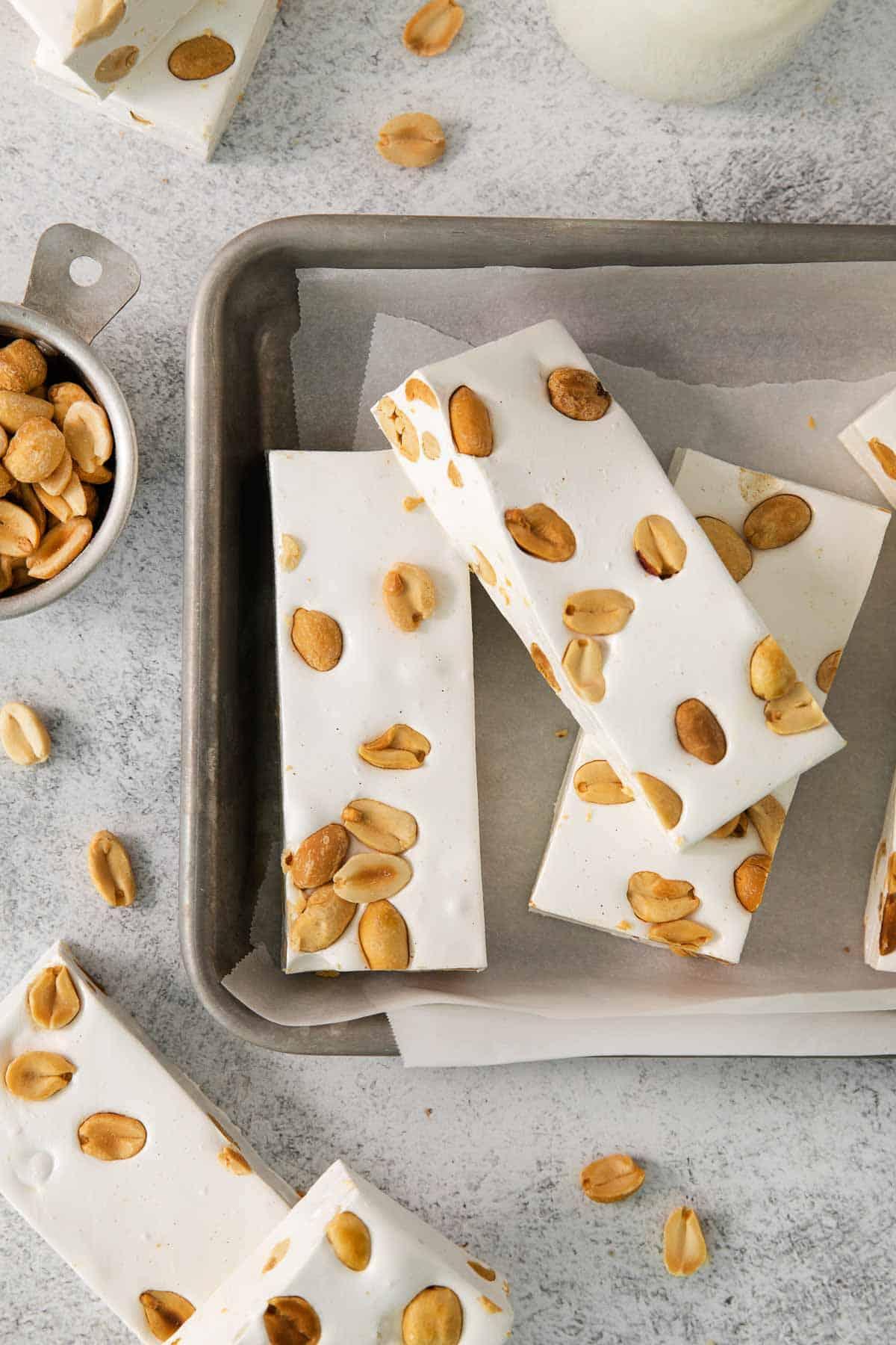 sliced nougat recipe with peanuts on baking sheet