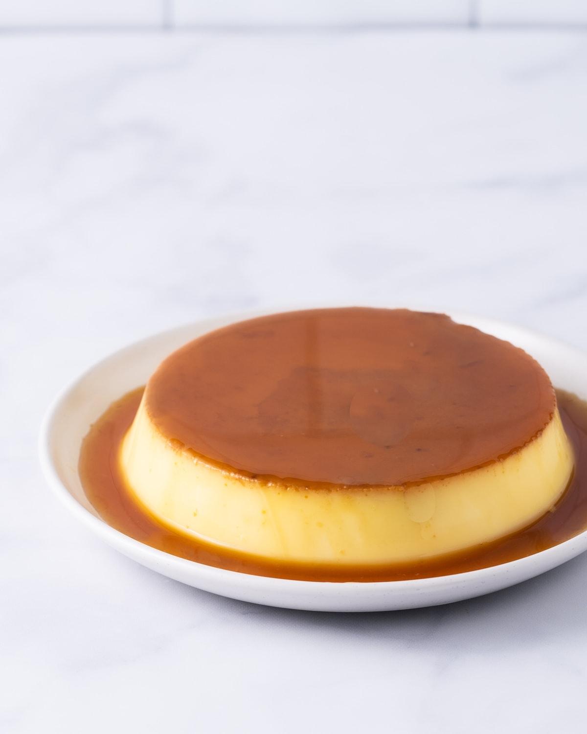 Banh flan on a white plate.