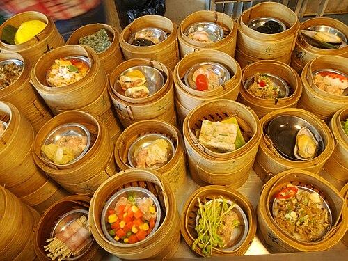 A server pushes a cart laden with bamboo baskets